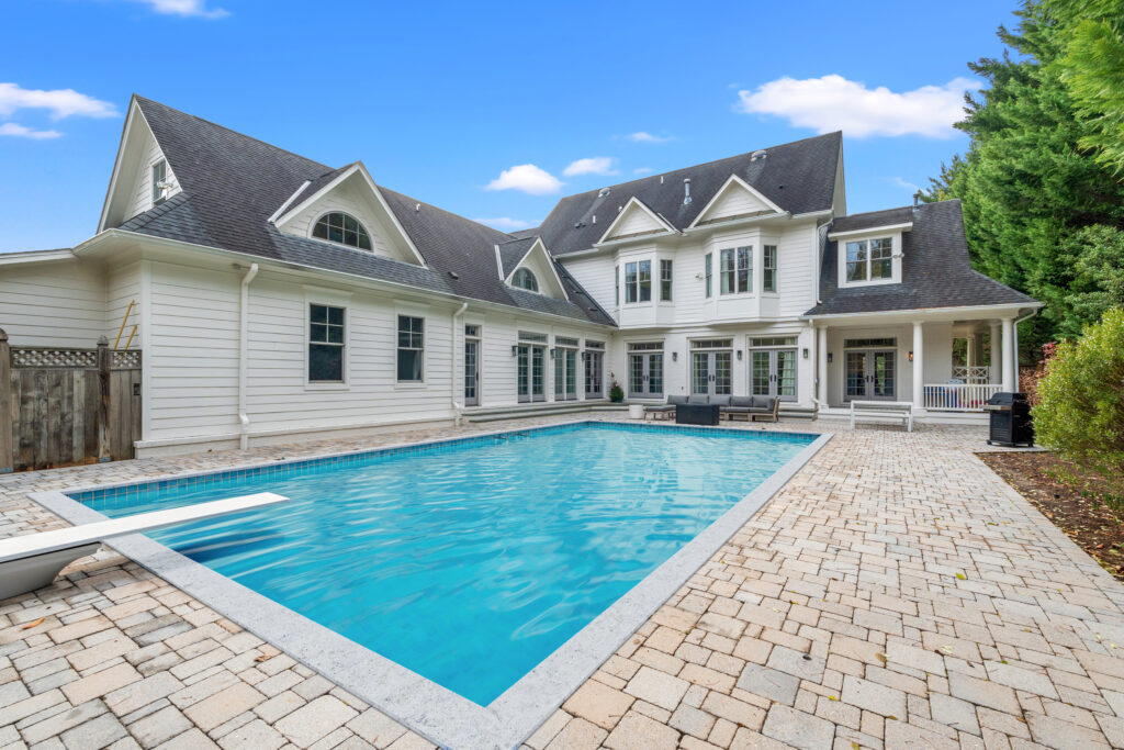 Private backyard pool of a luxury Bethesda home, designed for outdoor relaxation and entertainment.